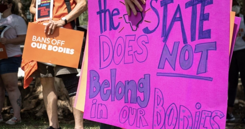 Signs protesting abortion bans BansOffOurBodies