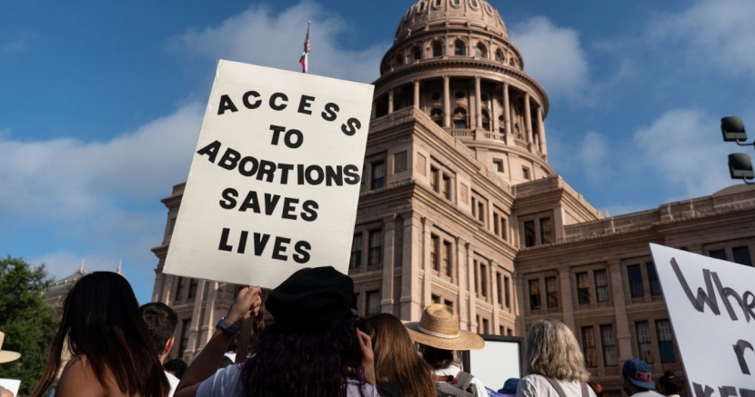 Texas Capitol with protest in front supporting abortion access 