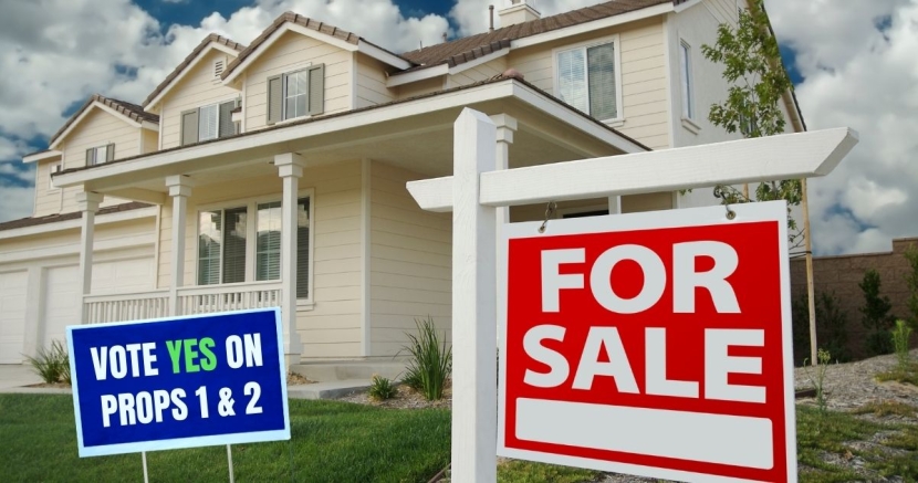 MayElection Home with a for sale sign and sign saying to vote YES on Props 1 and 2