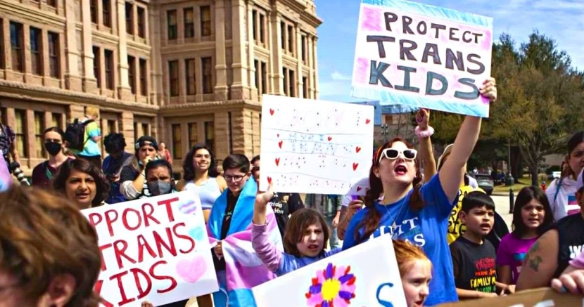 Protest with signs supporting trans kids ProtectTransKids