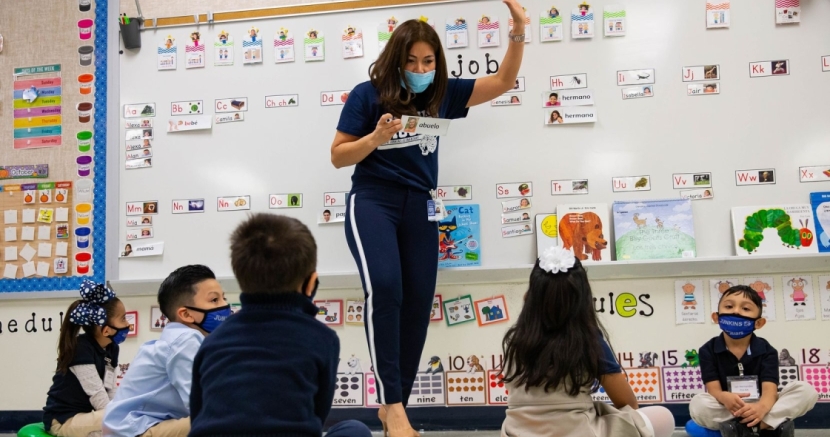 Teacher at white board teaching to her students. Teacher_shortage
